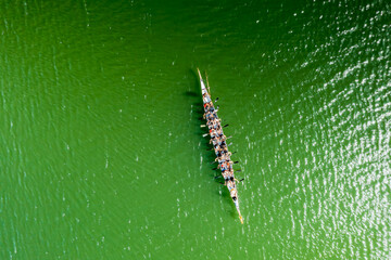 Dragon boat with team on the river and racing