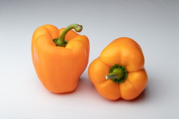 Two orange bell peppers isolated on white background
