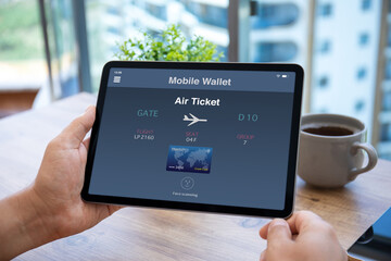 male hands holding computer tablet with airplane ticket application airlines