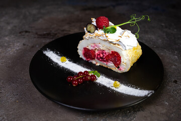 dessert sponge cake with raspberry filling and berries on plate