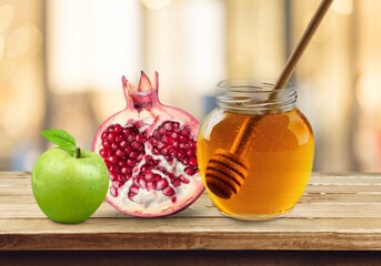 Honey, pomegranate, apples on wooden table. Rosh Hashana holiday