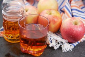 glass of apple juice and apple on table,