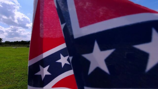 virginia graveyard with confederate flag flying in the wind