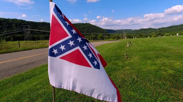 Flag of the confederacy, confederate flag flys in the breeze in virginia cemetary