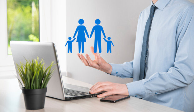 Hand hold young family icon. Family life insurance,supporting and services,family policy and supporting families concepts.Happy family concept.Copy space.mancupped hands showing paper man family