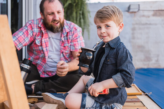 Charming boy with mate against smiling father