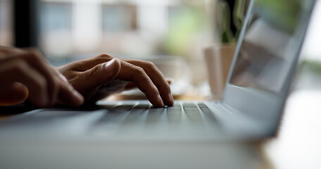 Close up of hands typing on computer keyboard panoramic banner, businessman or student using laptop...