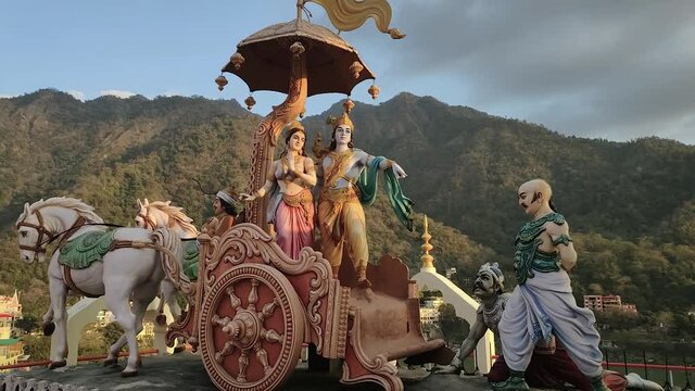 A sculpture group based on the Mahabharata in a Hindu temple in Rishikesh. A beautiful couple in a festive chariot