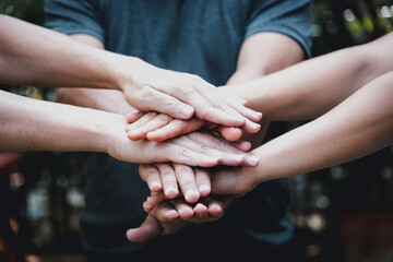 People join hands together for cooperation  more power to teamwork,partnership and collaboration .to drive business goal achievement,copy space,selective focus.