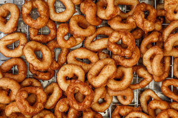 Fresh, crispy, delicious donuts are deep-fried.