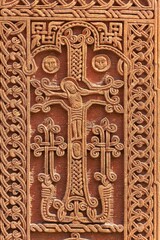 Fragment of an ancient Armenian khachkar with the crucifixion of Christ in Yerevan, Armenia.