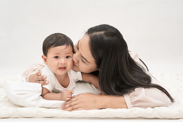Fototapeta na wymiar Mother kisses the baby sweetly and sweetly.