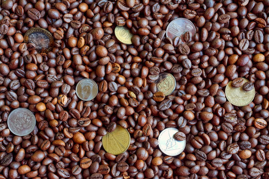 a few coins on the background of freshly imagined coffee