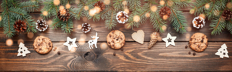 Christmas background with Chocolate chip cookies and wooden decorations. Eco friendly, zero waste. New year's backdrop. Flat lay, top view. Copy space. Banner