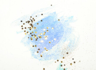 Golden glitter and glittering stars on abstract blue watercolor splash in vintage nostalgic colors