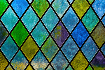 stained glass window of colored glass. Colored glass of different colors, diamond shape. Image of a...