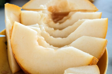 Plate with yummy melon slices on table close-up