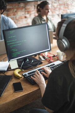 High angle view of female hacker coding over computer in office
