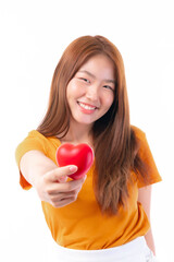 Portrait of smiling a beautiful Asian young woman holding red heart in hand on white background- Valentine day concept