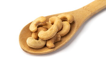 Cashew nuts in a wooden spoon isolated over white background