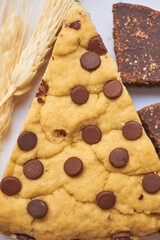 Detail of slice of chocolate pie, with chocolate chips, with toppings on the side.
