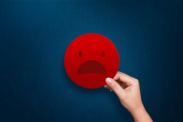 Customer giving bad emoticon for rating on blue background. Service rating, feedback, satisfaction...