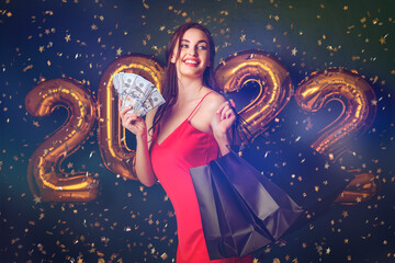 Woman with dollars and purchases. New Year shopping. Black Friday. 2022 balloons. sales. Confetti 