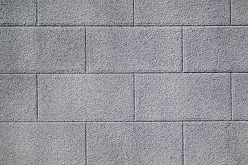 Texture details of brick wall roughcast painted grey.