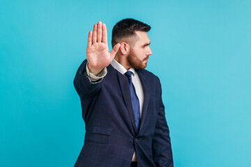 Stop! keep your distance. Serious bearded man wearing official style suit standing with stop hand...