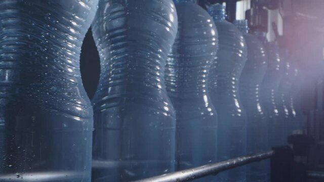 Water factory bottling pure spring water into bottles on automatic conveyor line