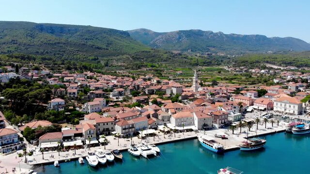 Drone shot on the Croatian resort island of Hvar in the Adriatic Sea. View from the drone to the port. Boats and ships on the shores of the Adriatic Sea in Croatia. Mountains on the island of Hvar. 