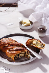 Swirl brioche with poppy seeds served with butter and jam. Poppy seed braided or roll bread, Babka. Traditional sweet Christmas bread