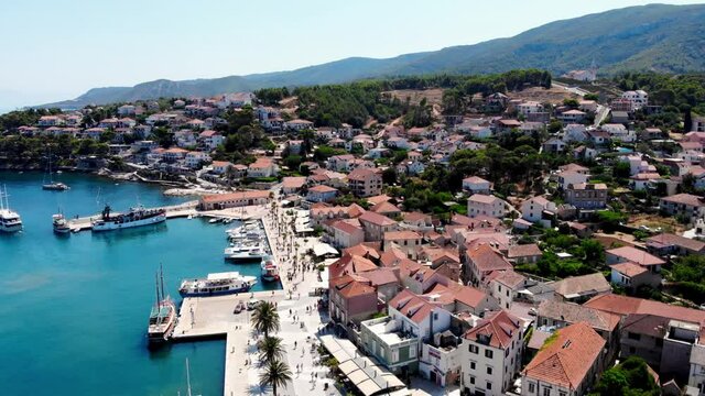Drone shot on the Croatian resort island of Hvar in the Adriatic Sea. View from the drone to the port. Boats and ships on the shores of the Adriatic Sea in Croatia. Mountains on the island of Hvar. 