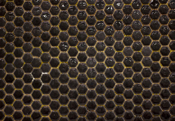 small block mosaic glossy black honeycomb ceramic tile background close-up
