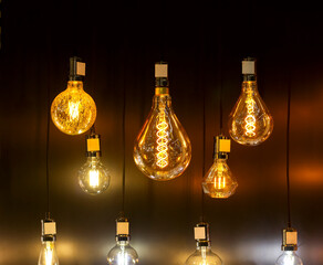 Fototapeta na wymiar stylish vintage round spiral light bulbs hanging group glow