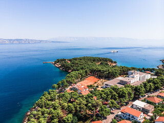 Naklejka na ściany i meble Drone shot on the Croatian resort island of Hvar in the Adriatic Sea. View from the drone to the port. Boats and ships on the shores of the Adriatic Sea in Croatia. Mountains on the island of Hvar. 