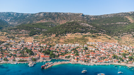 Fototapeta na wymiar Drone shot on the Croatian resort island of Hvar in the Adriatic Sea. View from the drone to the port. Boats and ships on the shores of the Adriatic Sea in Croatia. Mountains on the island of Hvar. 