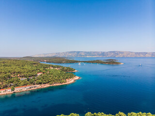 Fototapeta premium Drone shot on boat trips to the nearby Paklinsky Islands. Secluded beaches and coves in Croatian island of Hvar. Dubovitsa, and lavender fields frame from drone. Drone shot on Croatian island