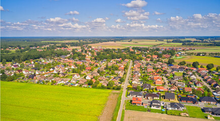 Aerial view of a village on the edge of the Luneburg Heath in northern Germany with single family houses on small plots of land - obrazy, fototapety, plakaty