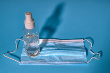 Sanitizer gel or antibacterial soap and face mask for coronavirus preventive measure, top view