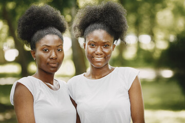 Portrait of a two smiling young african-american girls in a park