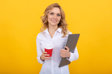 Happy girl student with laptop hold takeaway coffee drink in paper cup yellow background, break