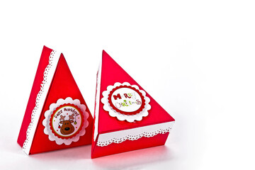 Merry christmas red triangular shape gift boxes on white background with space for text
