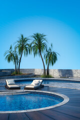 Fototapeta na wymiar Vertical 3D rendering of a summer vacation resort swimming pool with sun loungers, palm trees and clear blue sky.