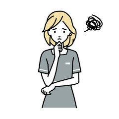 立って手をあごにあてて困っているエステ店員の女性