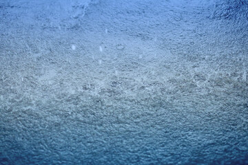 Blue color tone of close up rain water drop falling to the floor in rainy season.