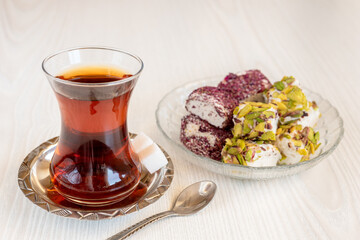Traditional Turkish tea in a glass with sweets