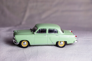 Old green soviet toy car on a white background