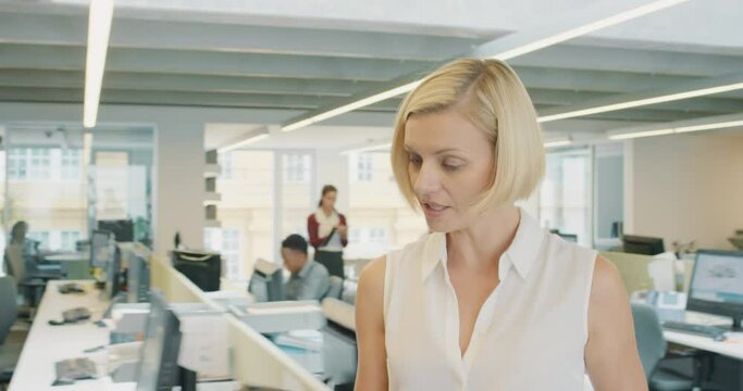 Powerful Businesswoman leader making decisions walking through busy office under pressure from deadlines to business meeting