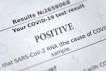Fototapeta premium Laboratory report with positive test result by using rapid test device for COVID-19